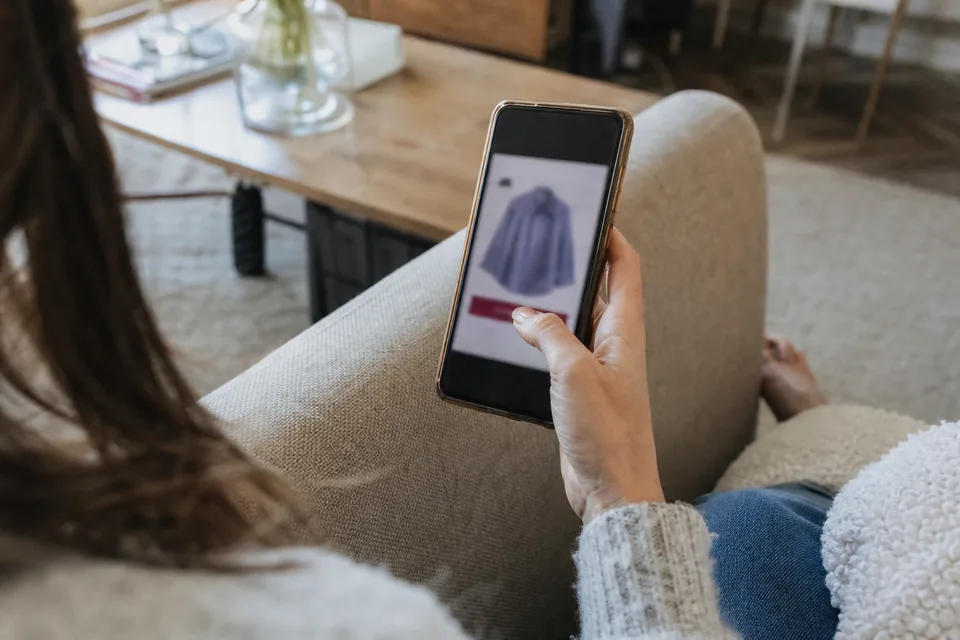E-commerce manager checking a checkout page on a phone